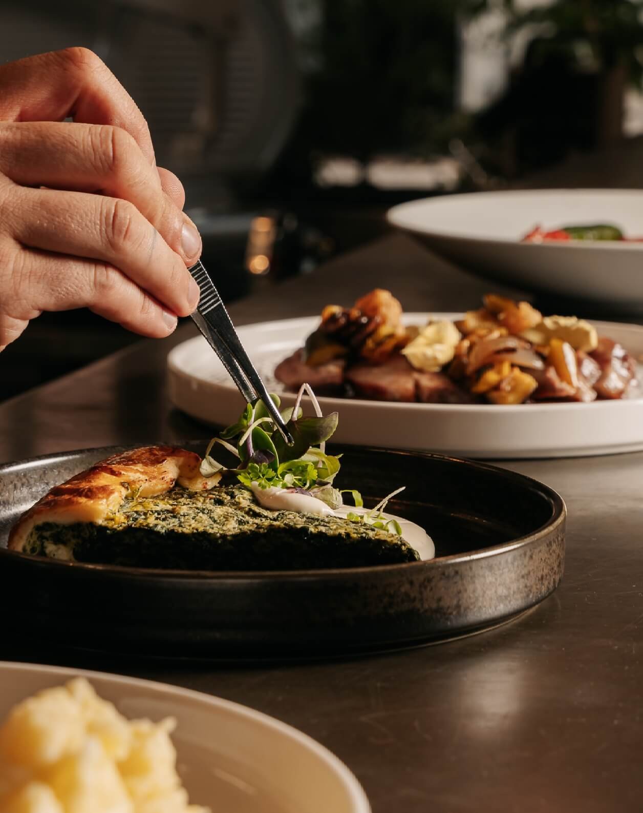 Chef prepara piatto gourmet con verdure fresche al ristorante I Morosetti Verona